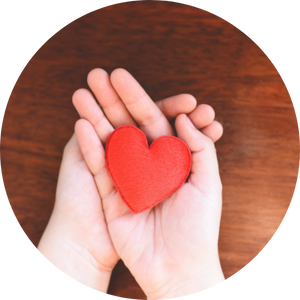  hands cradling heart shaped pillow