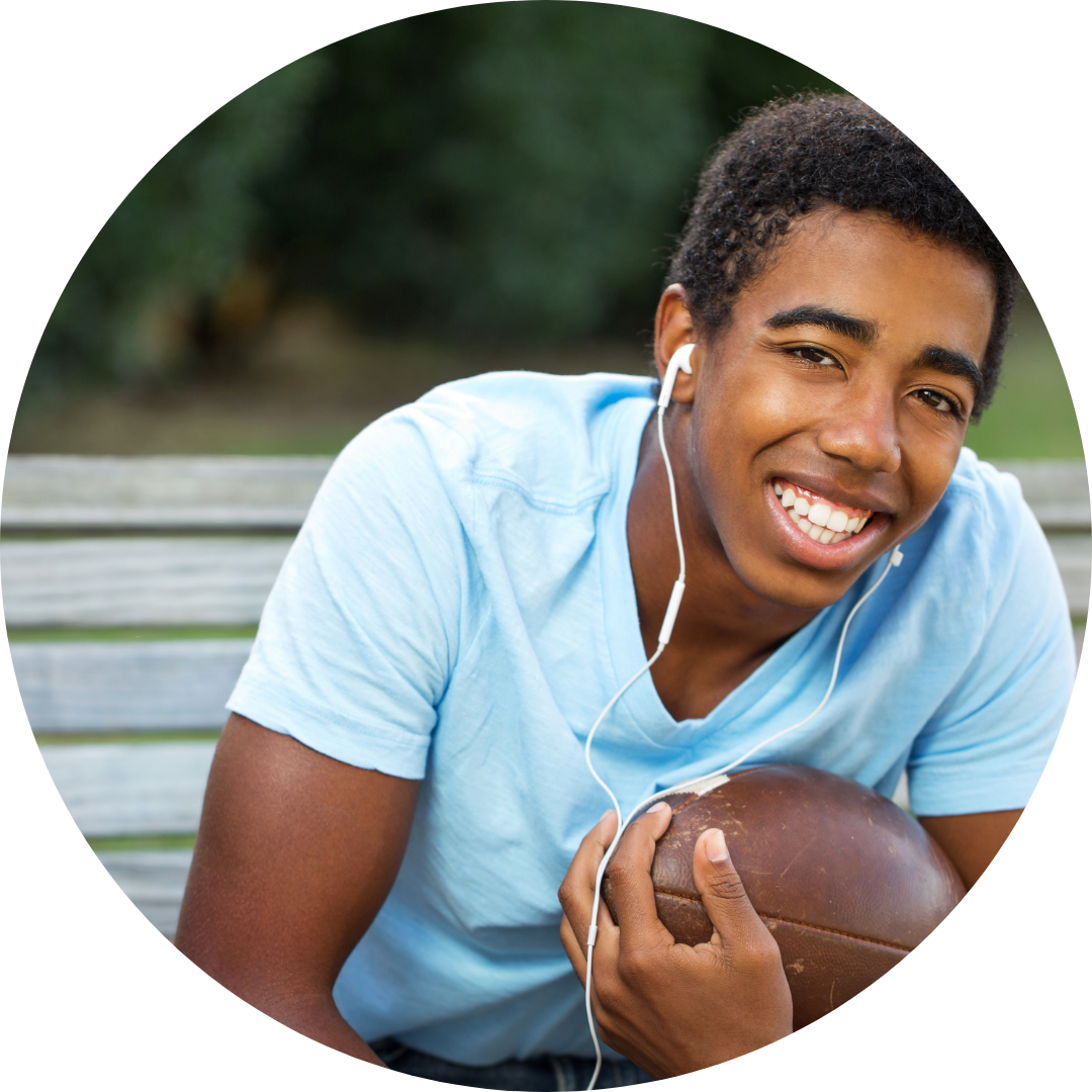  teen boy holding football